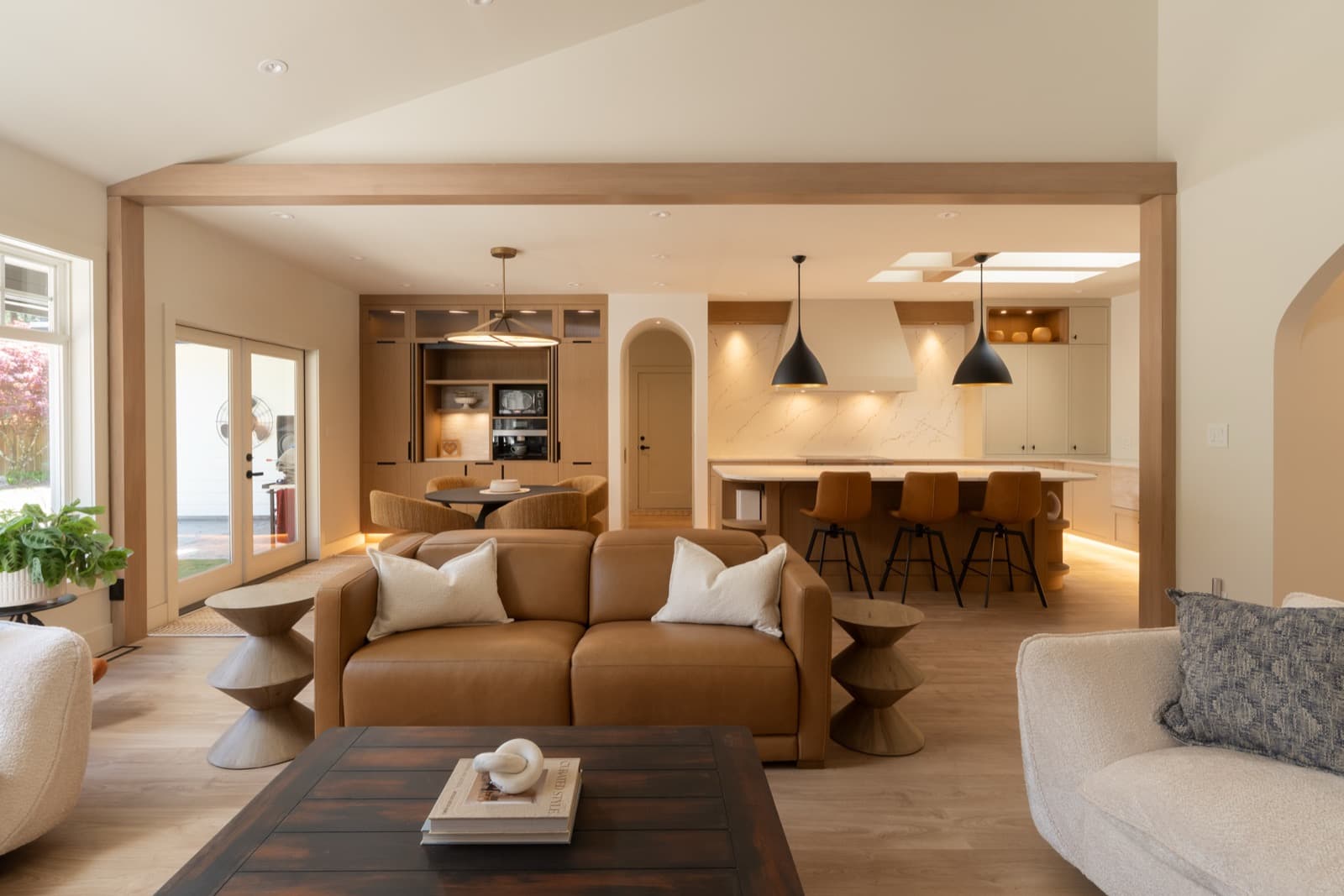 Completed River's Edge kitchen with full-height stone backsplash and wood cabinetry